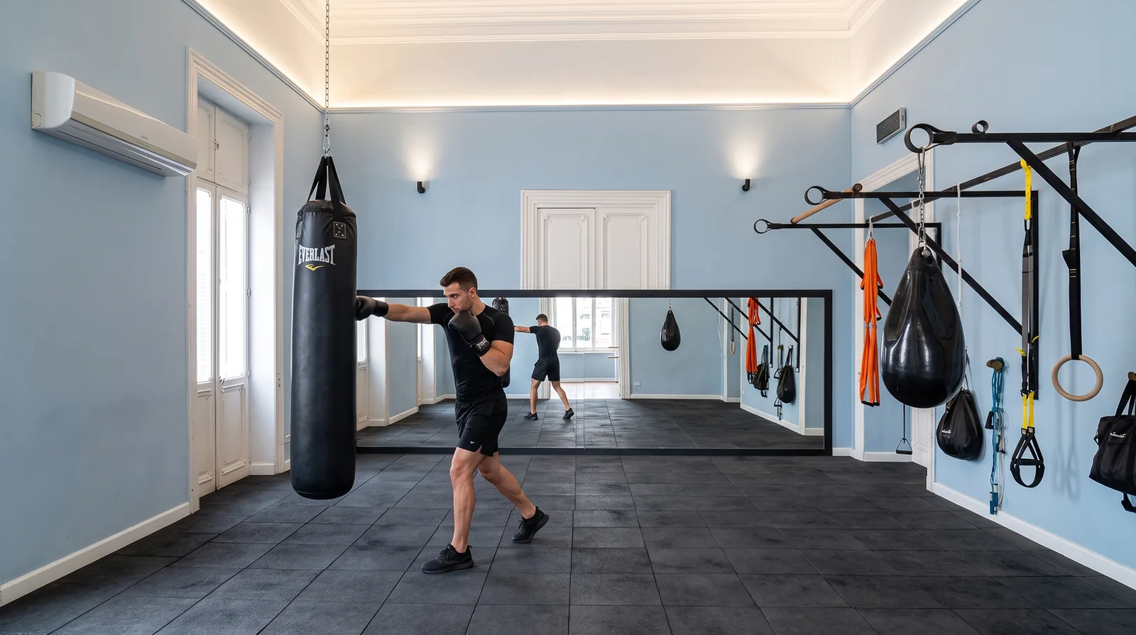 A member training on the bag in the Canopus fitness room